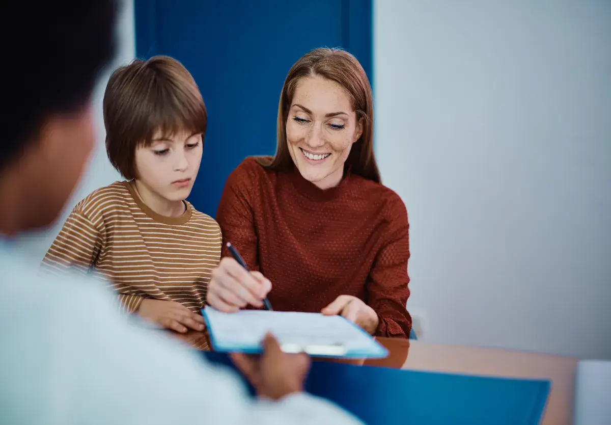 happy-mother-signing-medical-document